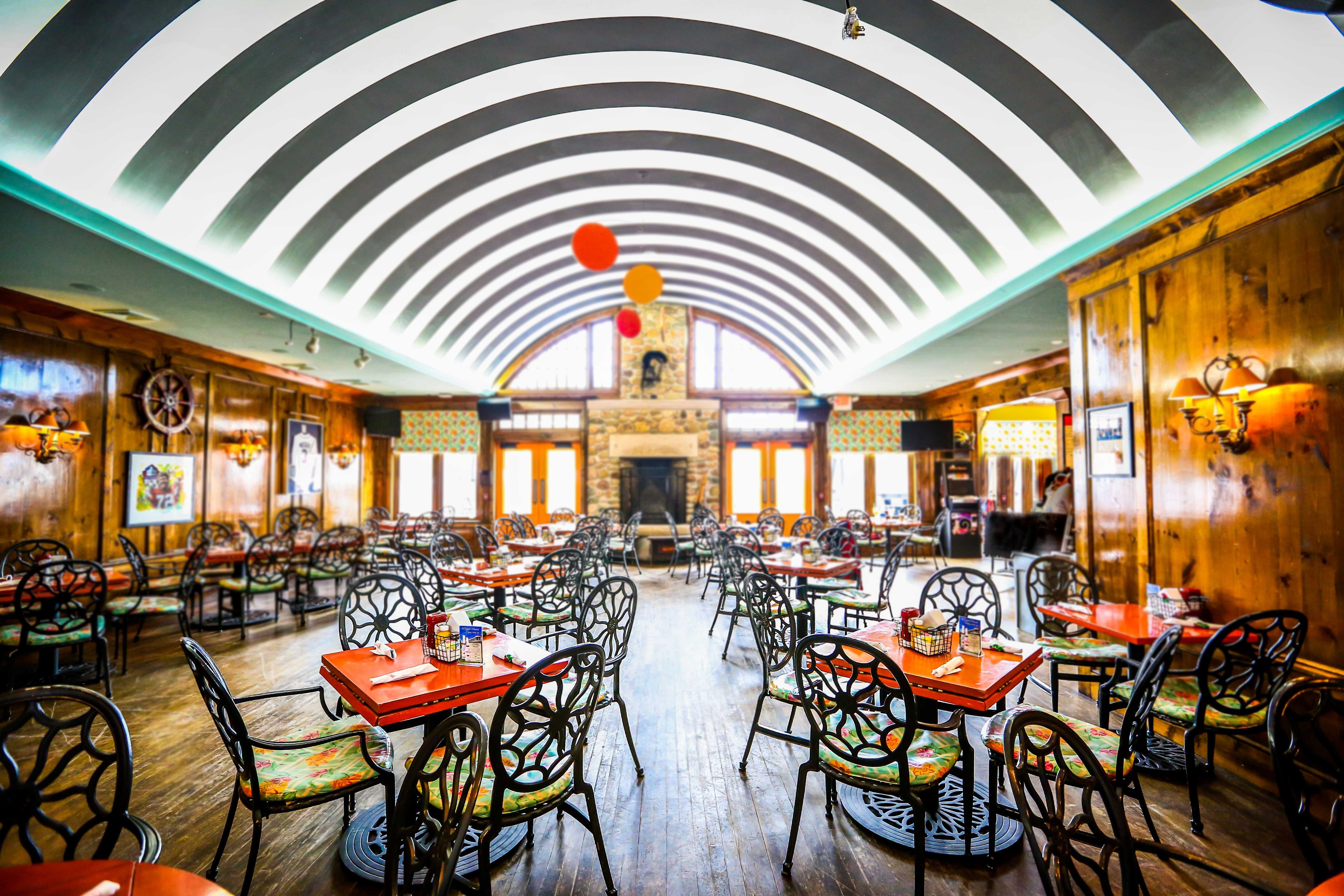 Image of the Gate House restaurant with casual seating and diner ambiance. Grand Hotel, a member of Historic Hotels since 2001, dates to 1886. It is located in Mackinac Island, Michigan.